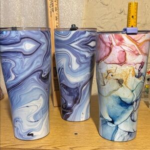 Three 32 oz patterned cups. All with lids.